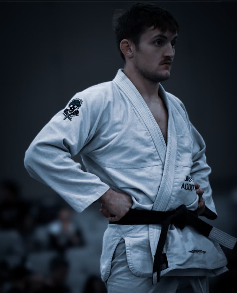 Professor London Horn in a white gi and black belt at competition