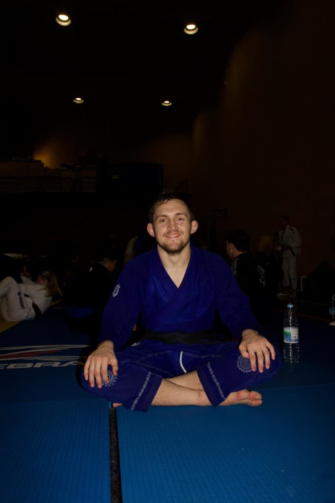 Professor London Horn smiling on the competition mats in a blue gi