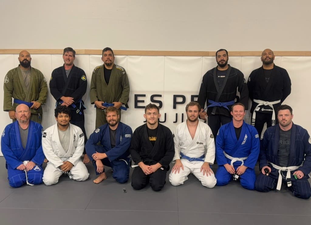 Professor London Horn with students on the academy mats